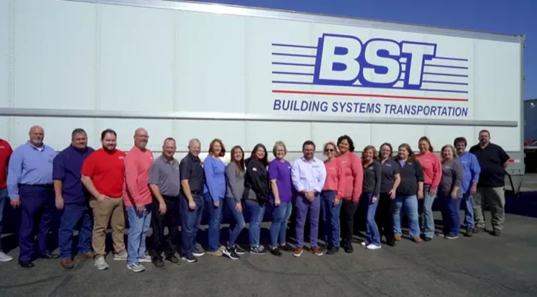 BST Building Systems Transportation team standing in front of company trailer