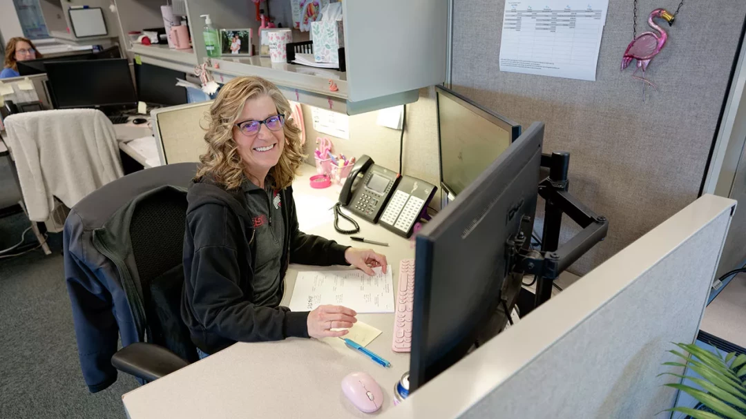 BST office employee working at computer inside logistics office