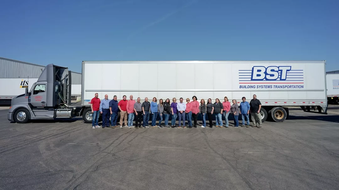 BST Building Systems Transportation team standing in front of company semi-truck
