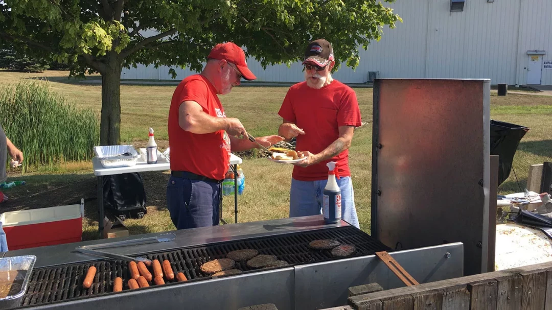 BST employees grilling food during outdoor company cookout event